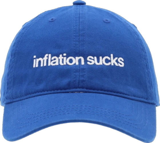 A blue baseball cap embroidered with the words “inflation sucks”.