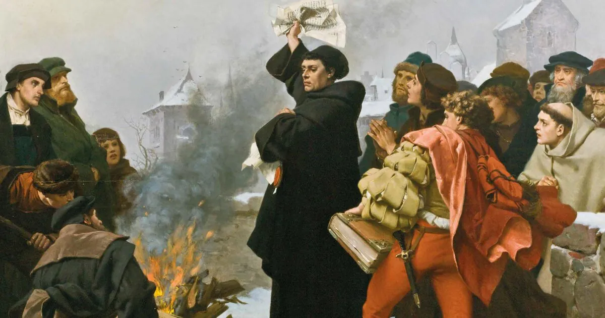 Luther holds the papal bull above his head beside a bonfire while a crowd of students watches.